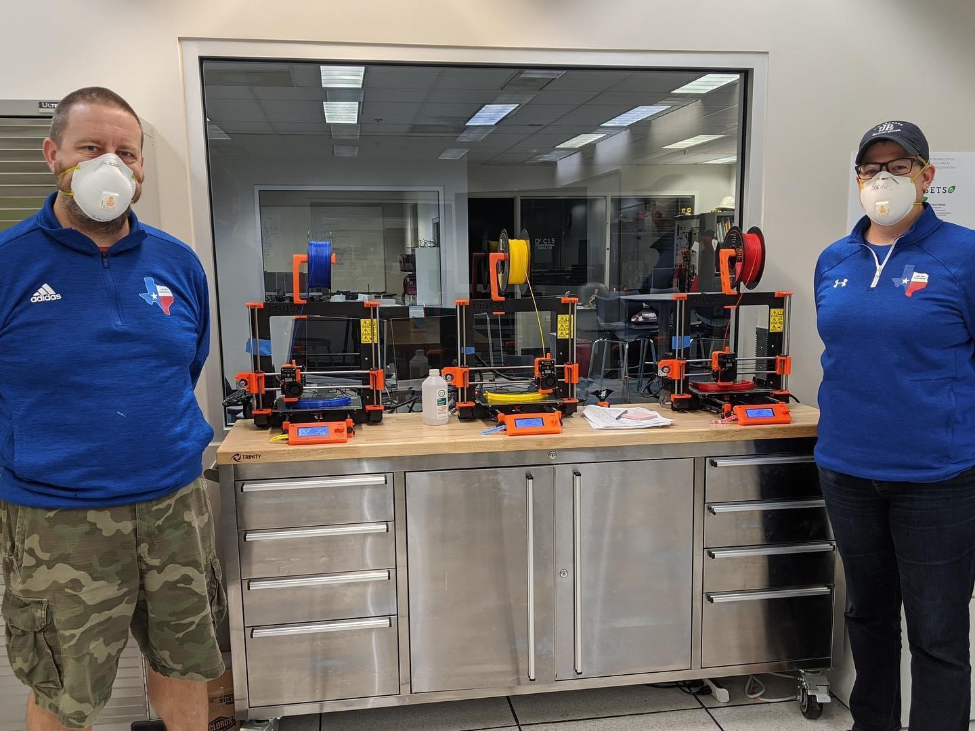 STEM teacher Jennifer Makins (right) and a colleague, Dave Cribbs, stand beside the 3D printers at Parish Episcopal School in Dallas.